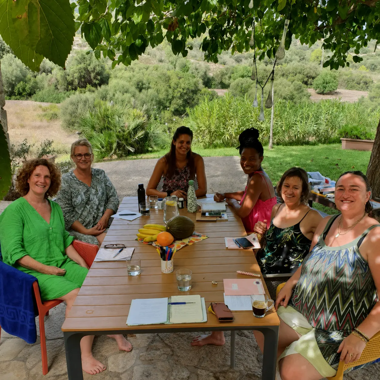 A workshop around the long outdoor table under the trees