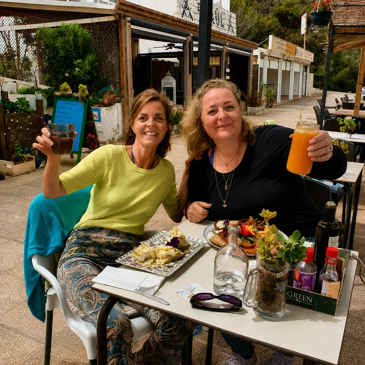 Two women sharing lunch at a small beach café